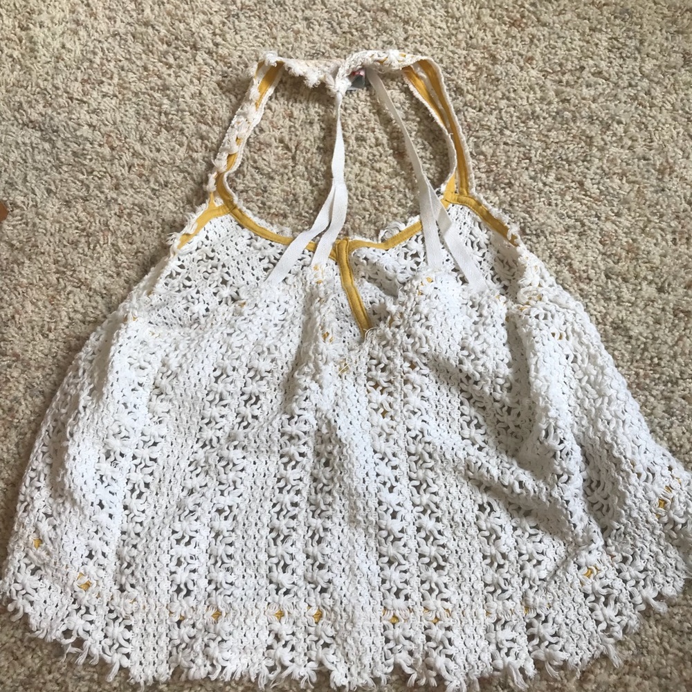 Four white tank tops